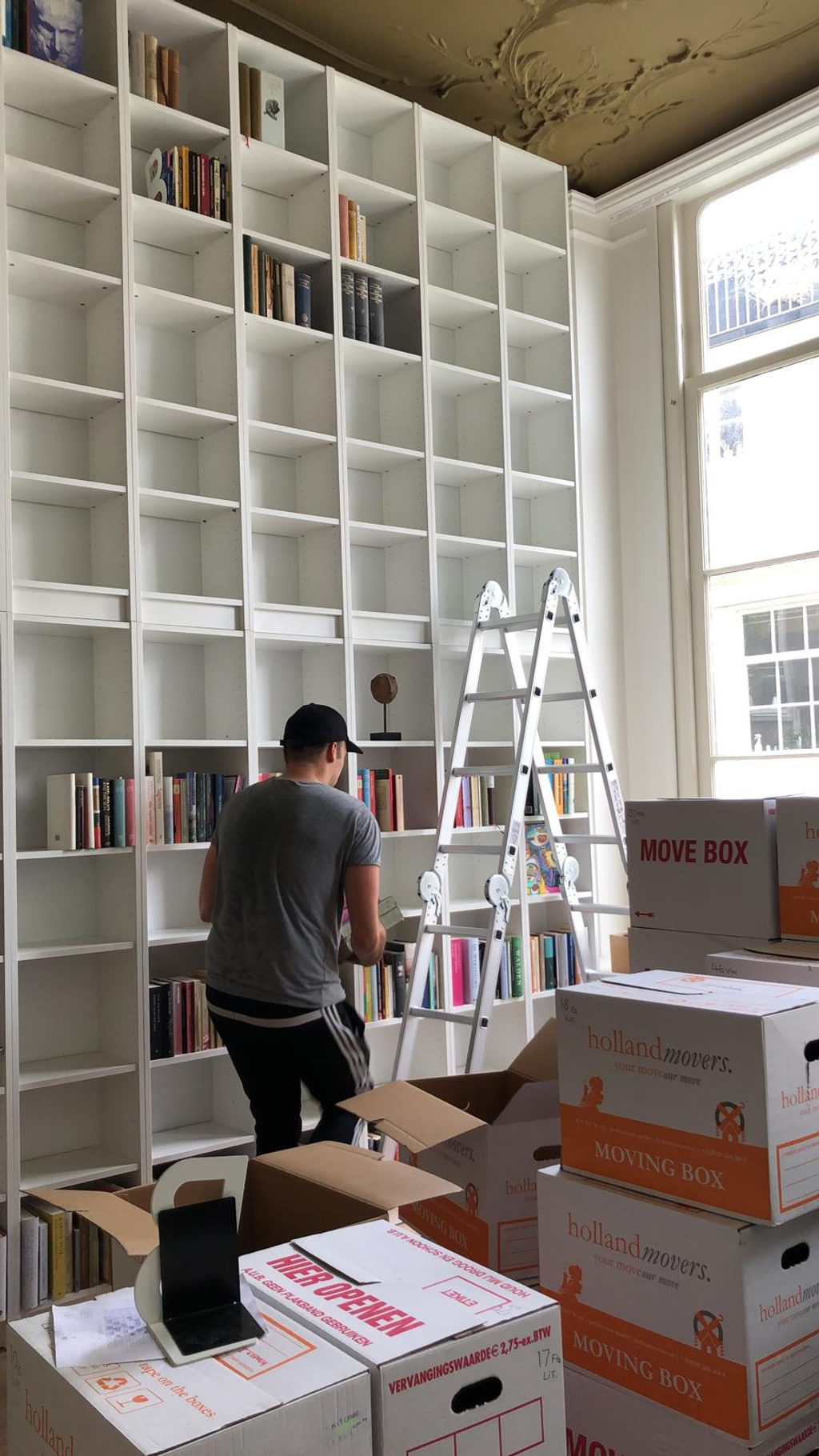 Aldorr Professional Folding Ladder with Platform. The ladder is shown in a room to be renovated. Affordable rental with BIYU.