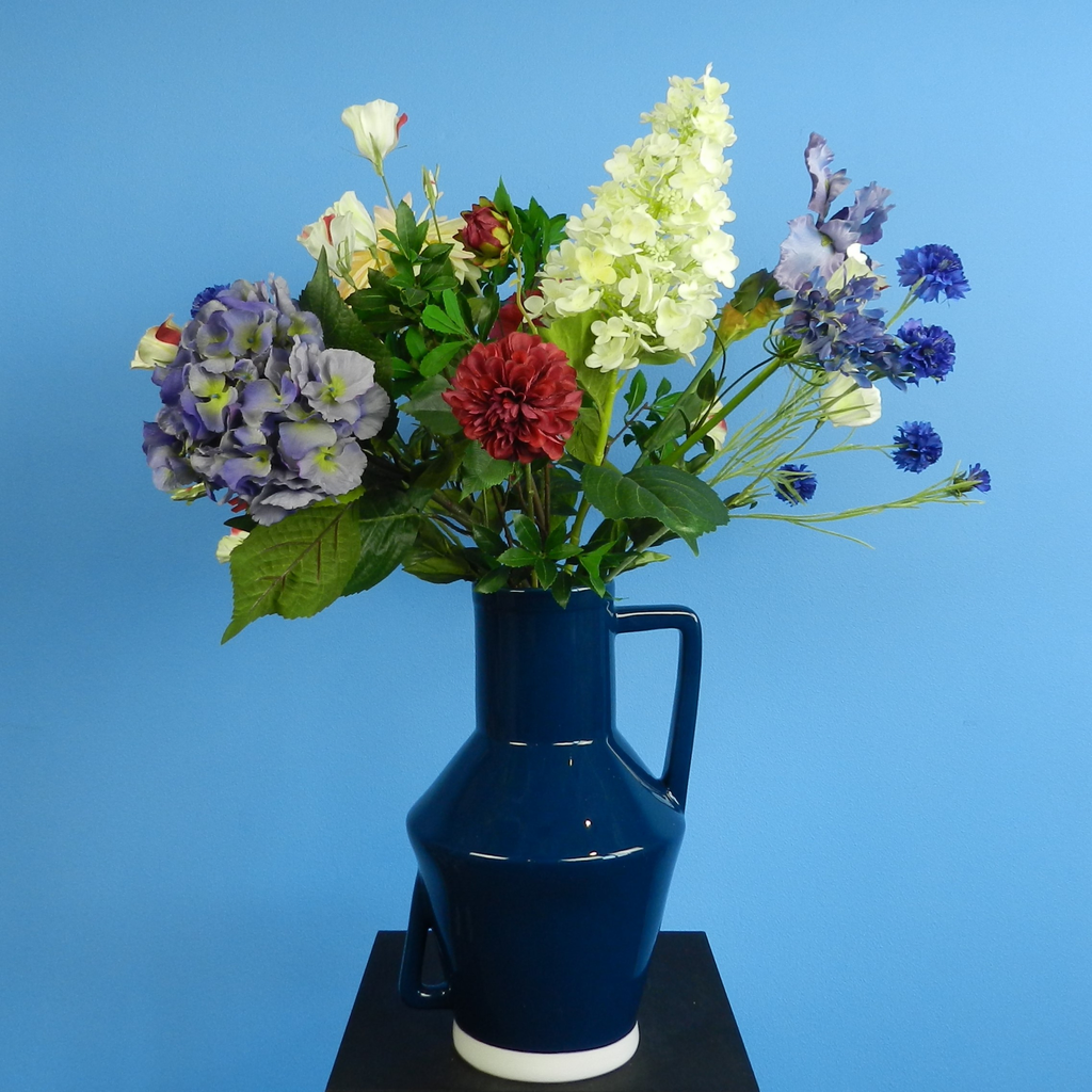 Rent these colorful red pink and blue artificial flowers and perennial flowers in a vase at BIYU