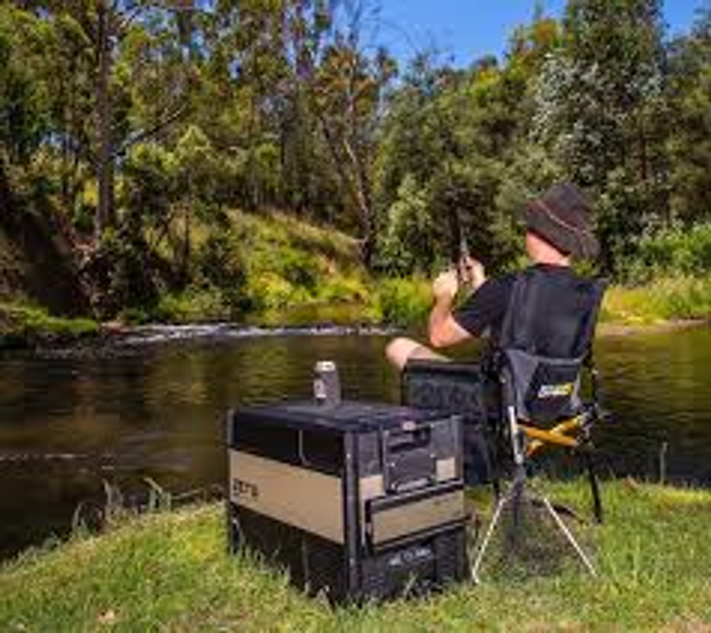 ARB Portable Electronic Freezer outside in nature during fishing. Affordable rental with BIYU.