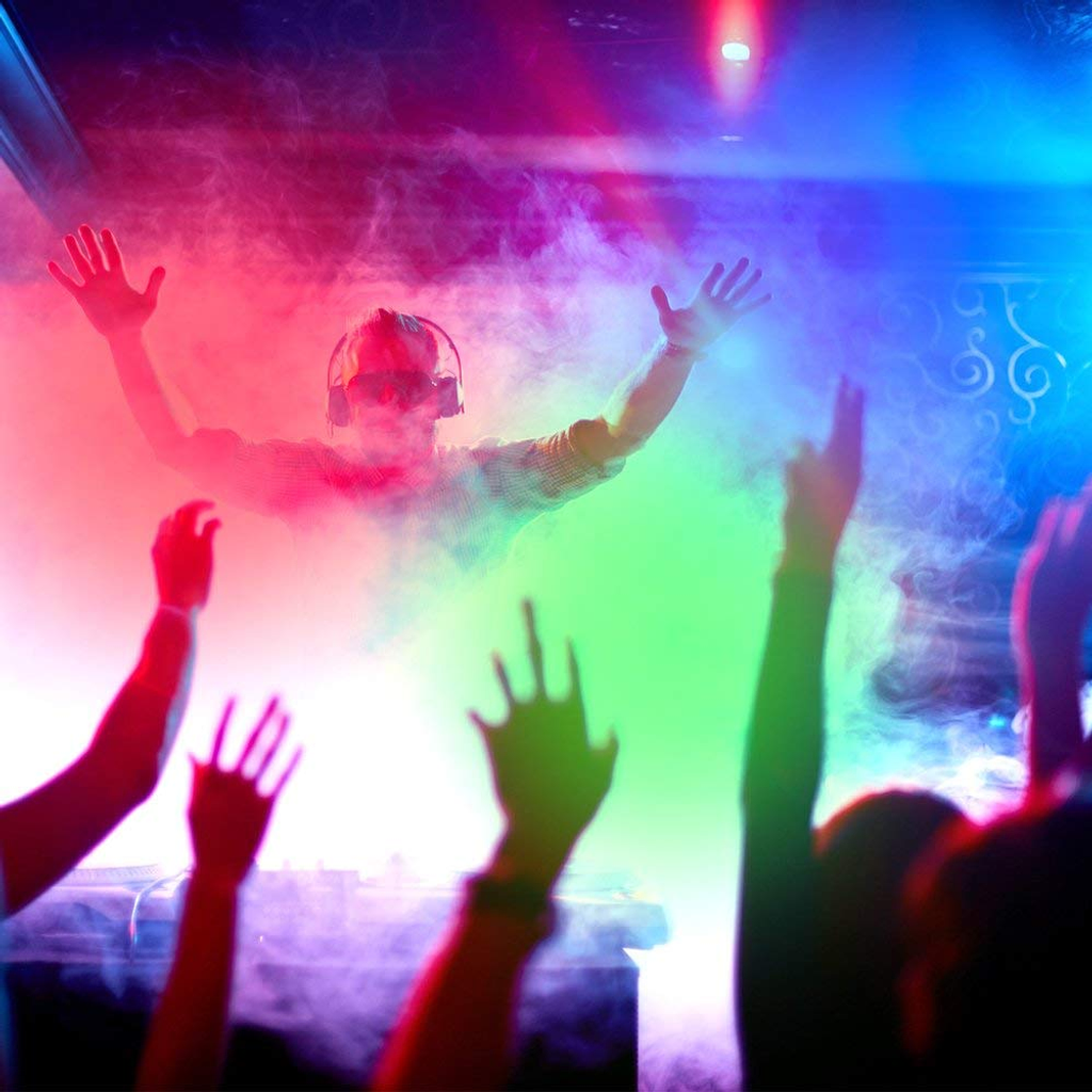 BeamZ Smoke Machine with RGB LEDs making colord smoke at a party with hands up and DJ. Affordable rental with BIYU.