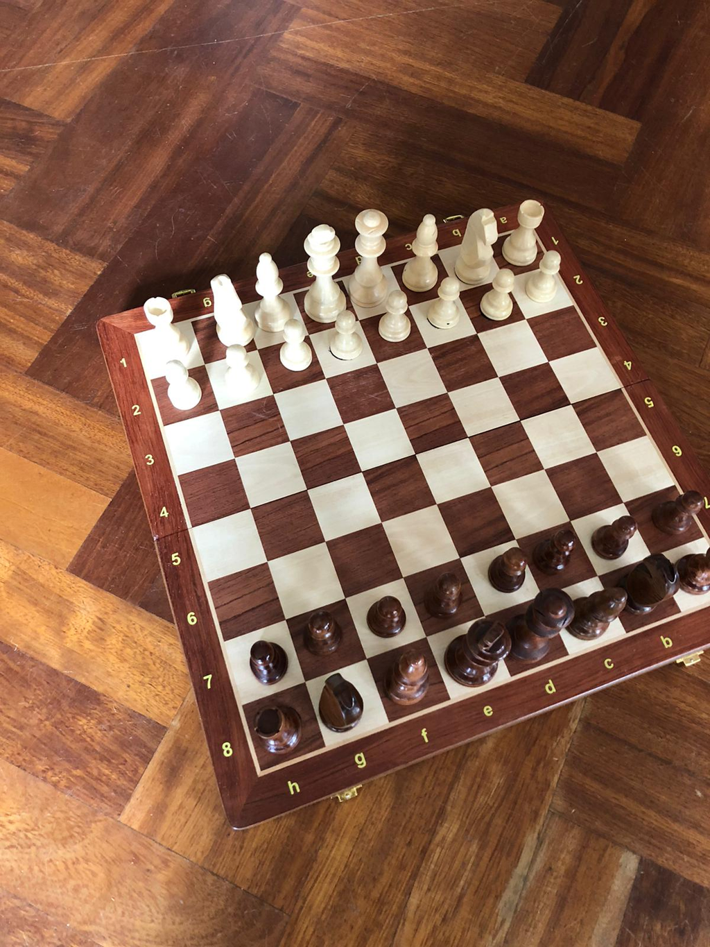 Wooden Chessboard with chess figures in start position. Affordable rental with BIYU.