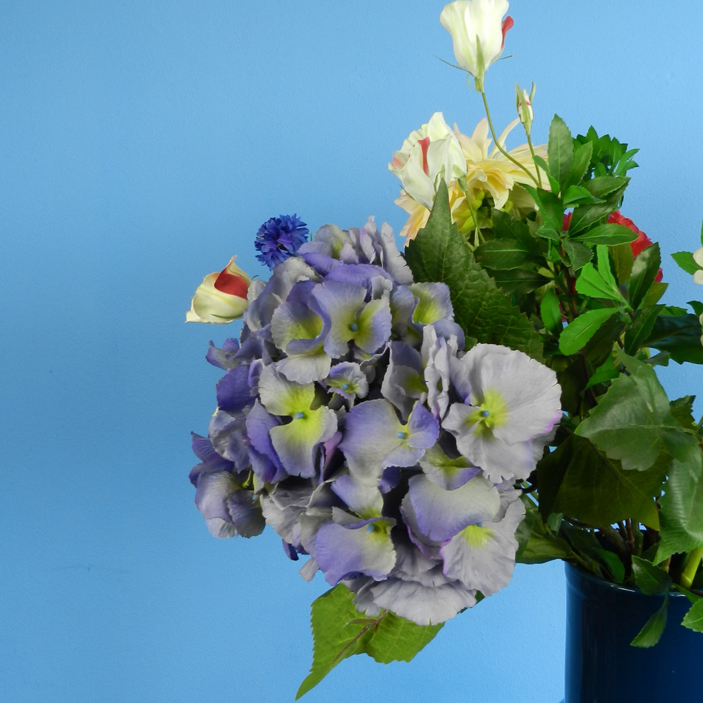 Rent these colorful red pink and blue artificial flowers and perennial flowers in a vase at BIYU